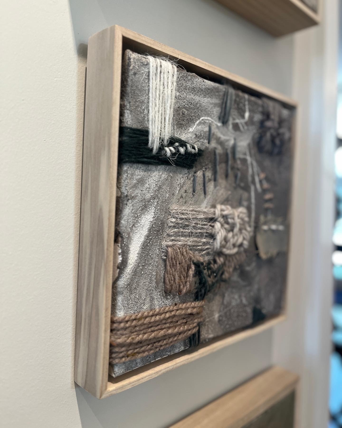 embroidered linen canvas detailed with coffee grounds, coffee, ink, with wool, leather, cotton, ground crystal quartz, in a handcrafted poplar frame.  in exhibition