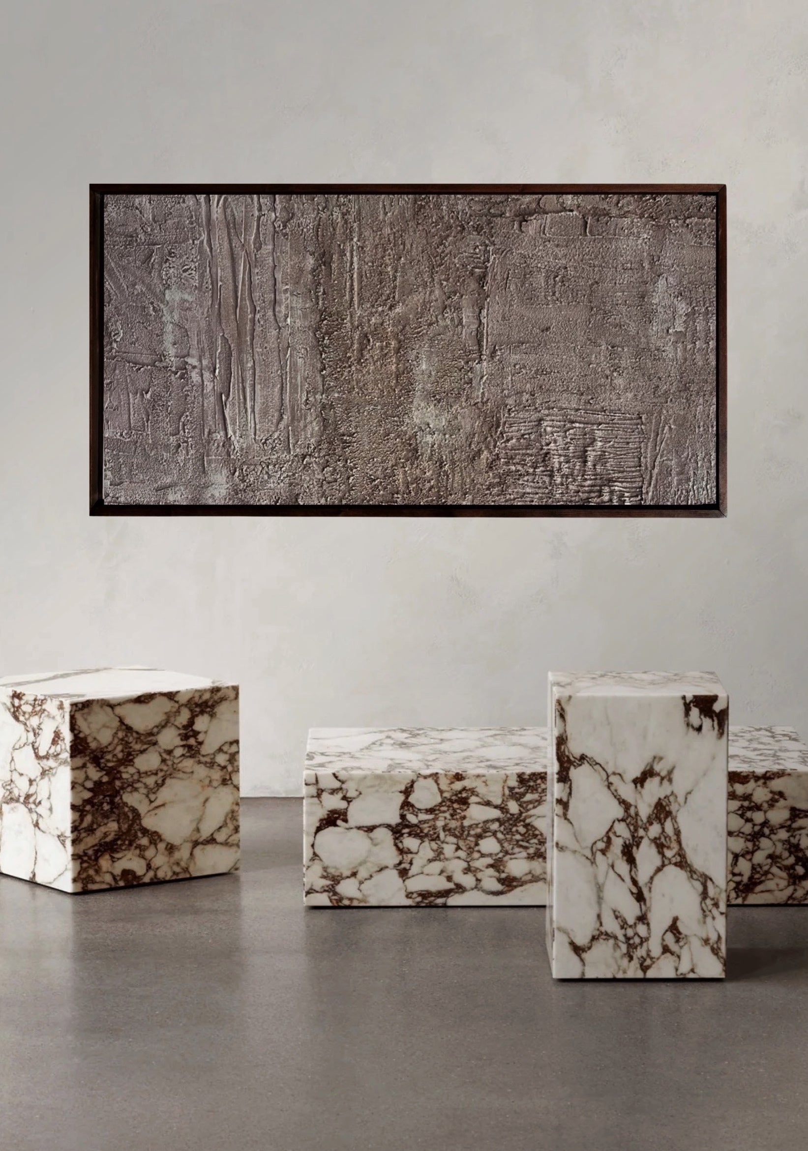 rose gold toned painting concrete, sand, raw pigment textured abstract contemporary painting housed in a walnut wood handcrafted frame. displayed in a modern interior designed home with marble furnishings.