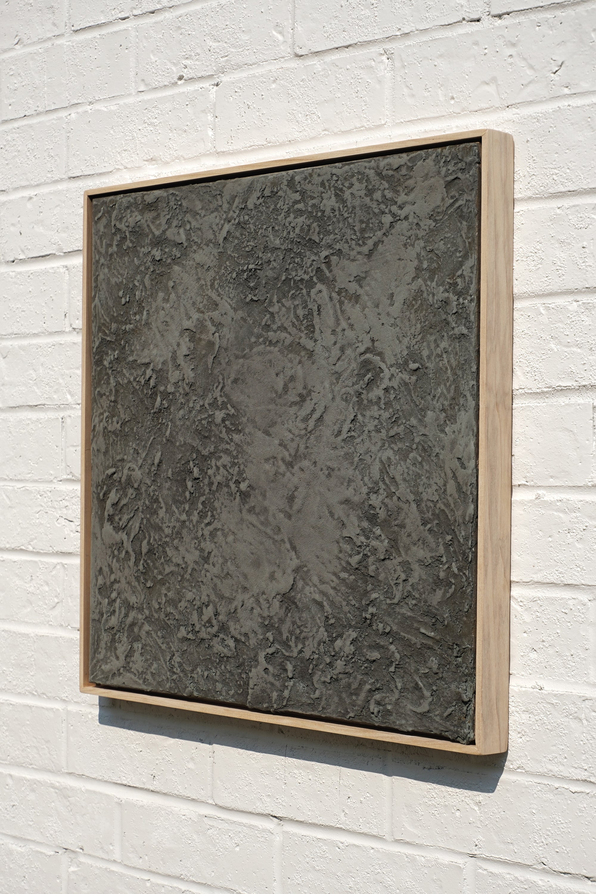 abstract textured concrete and sand painting housed in a handcrafted poplar wood frame.