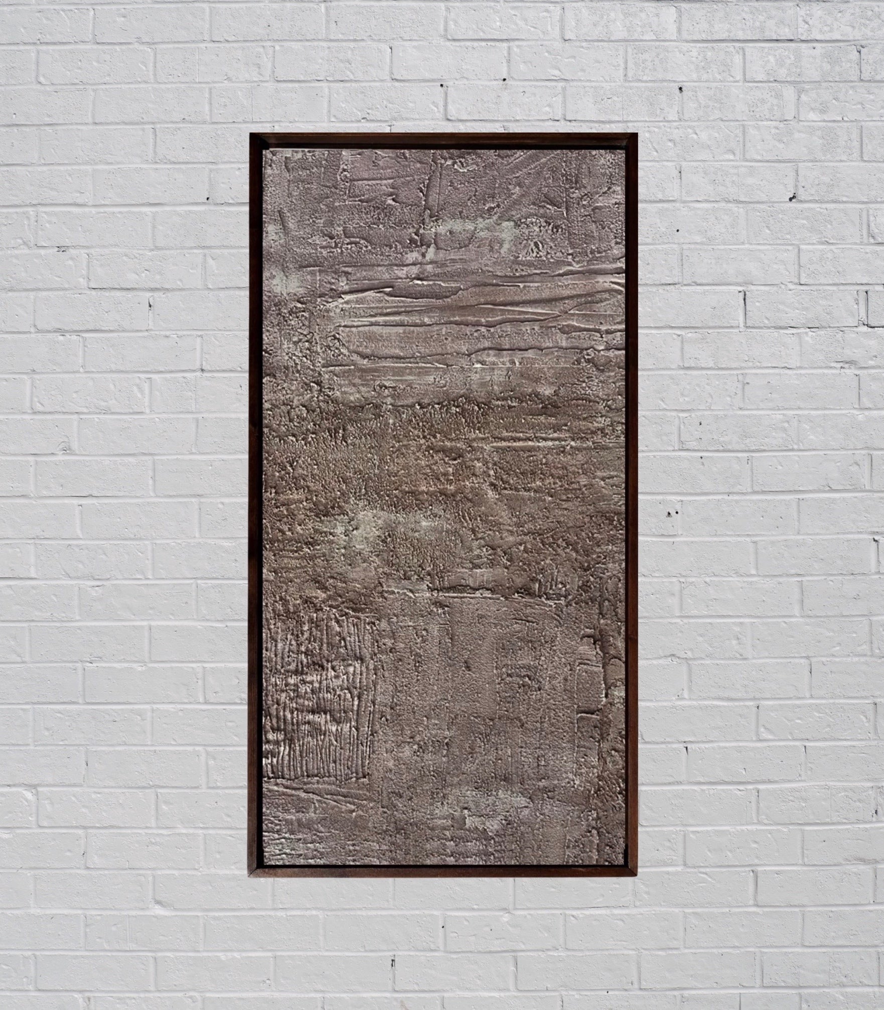 rose gold toned painting concrete, sand, raw pigment textured abstract contemporary painting housed in a walnut wood handcrafted frame. displayed in a modern interior designed home.