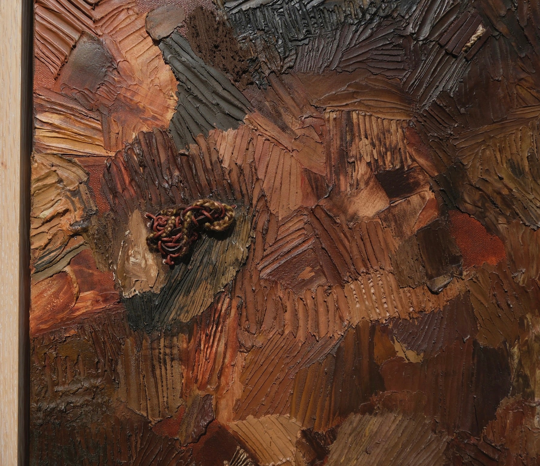 details of a textured sculptural artwork terracotta rust earth toned embroidered with leather 
