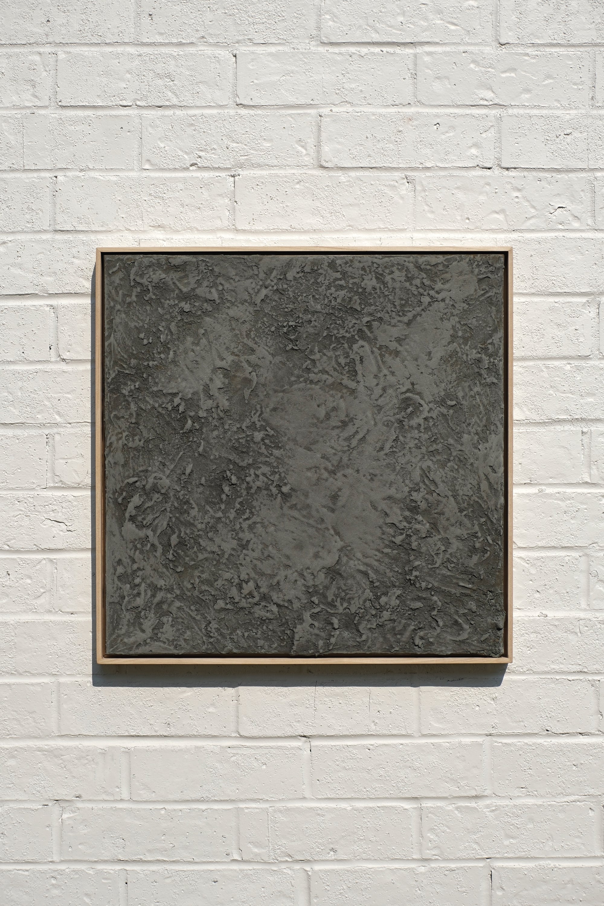 abstract textured concrete and sand painting housed in a handcrafted poplar wood frame.